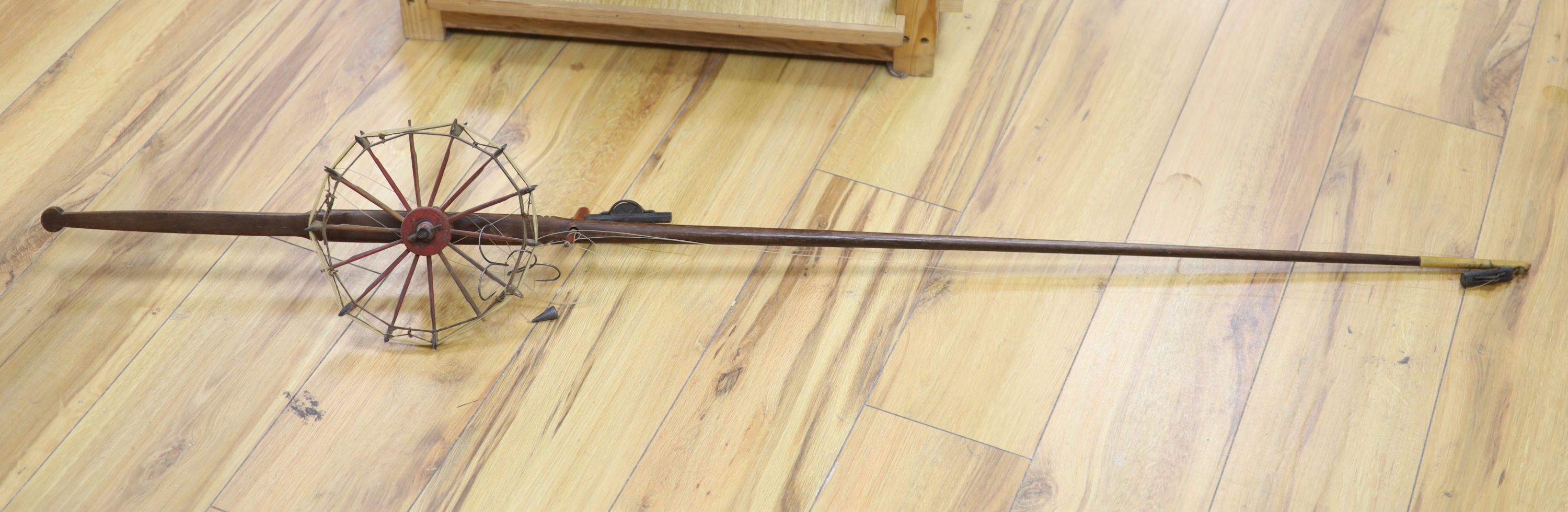 A Chinese wood and bamboo fishing rod with reel, Qing Dynasty, approx. length 142cm